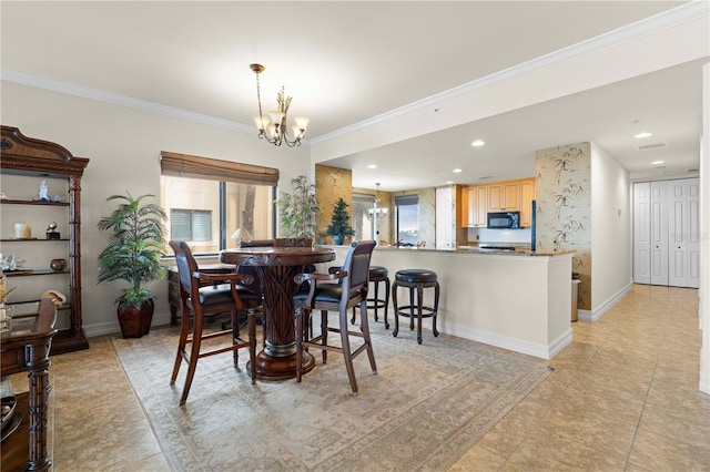 dining space featuring crown molding and a chandelier