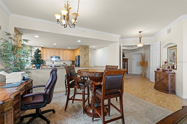 dining room with a chandelier and ornamental molding