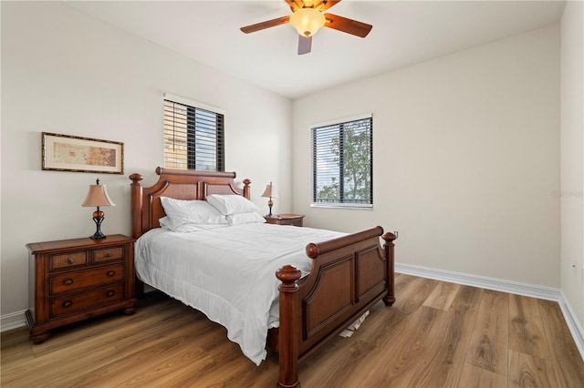 bedroom with wood-type flooring and ceiling fan