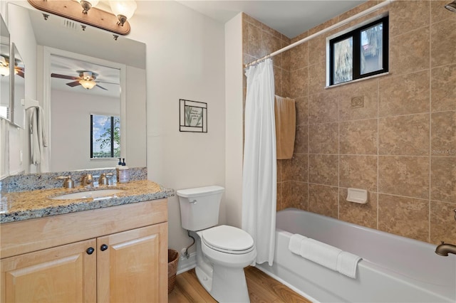 full bathroom featuring shower / bath combo, vanity, ceiling fan, hardwood / wood-style floors, and toilet