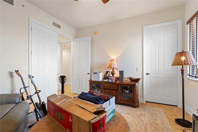 tiled bedroom featuring ceiling fan