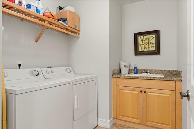 laundry room with washer and dryer, cabinets, and sink