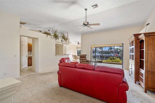 carpeted living room with ceiling fan, lofted ceiling, and a textured ceiling