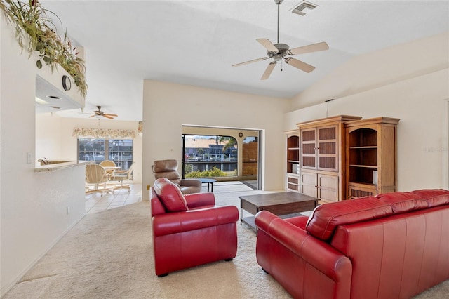 living room featuring ceiling fan, light colored carpet, and lofted ceiling