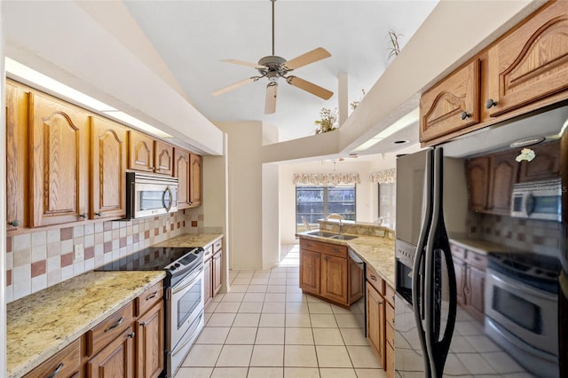 kitchen featuring ceiling fan, sink, backsplash, light tile patterned floors, and appliances with stainless steel finishes