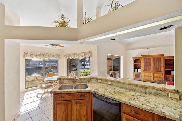 kitchen featuring dishwasher, lofted ceiling, sink, ceiling fan, and light tile patterned flooring