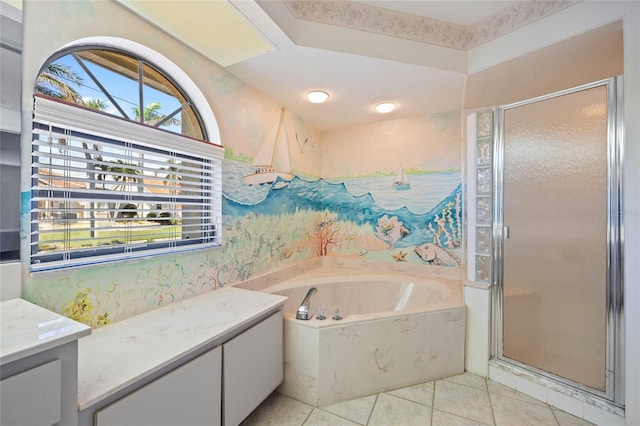 bathroom with tile patterned floors, vanity, and separate shower and tub