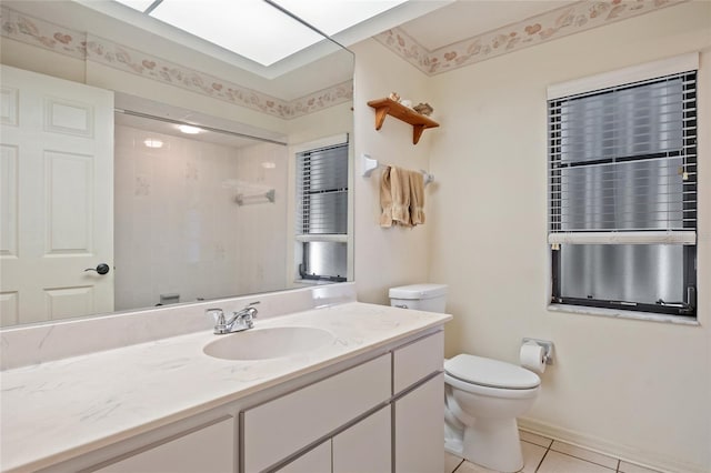 bathroom with toilet, a shower, vanity, and tile patterned floors