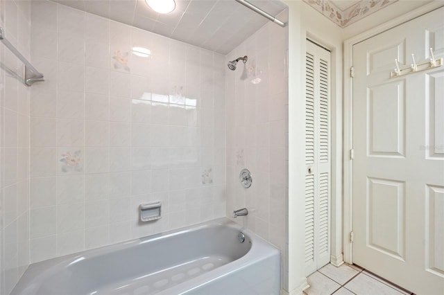 bathroom featuring tile patterned floors and tiled shower / bath