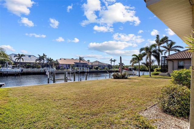 view of yard featuring a water view and a dock