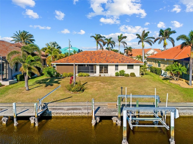 dock area with a lawn and a water view