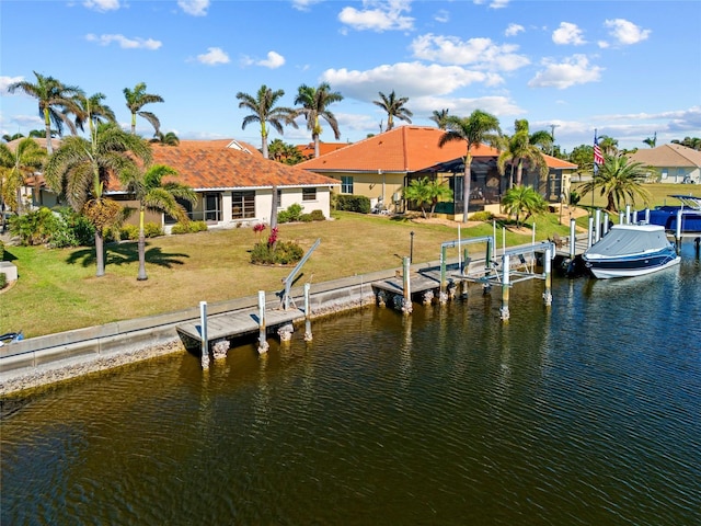 dock area featuring a water view and a lawn