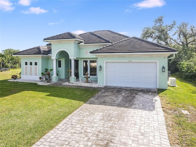 mediterranean / spanish-style house with a front lawn and a garage