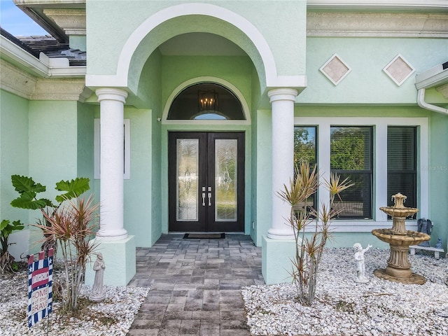 view of exterior entry featuring french doors