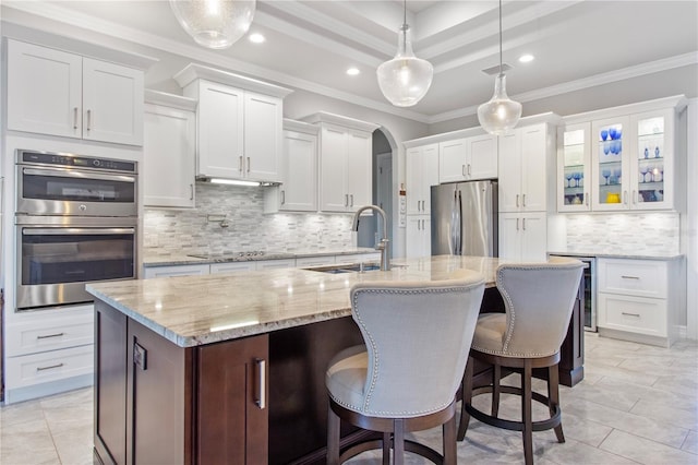 kitchen featuring stainless steel appliances, white cabinetry, and sink