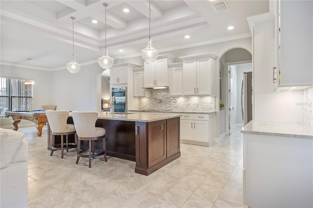 kitchen with crown molding, white cabinets, decorative light fixtures, and pool table