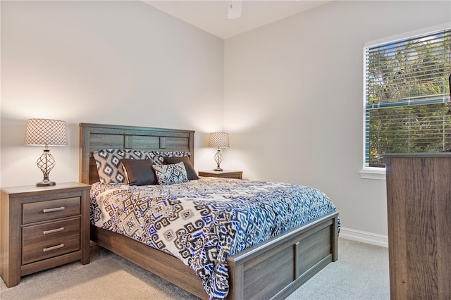 bedroom featuring ceiling fan and light carpet