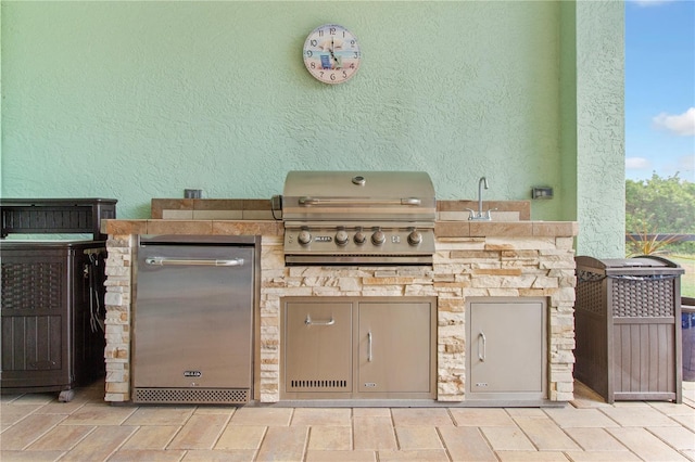 view of patio / terrace featuring sink, area for grilling, and a grill