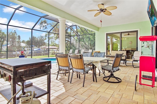 sunroom featuring ceiling fan and a swimming pool