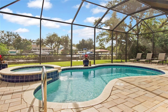 view of swimming pool featuring glass enclosure, an in ground hot tub, a yard, and a patio