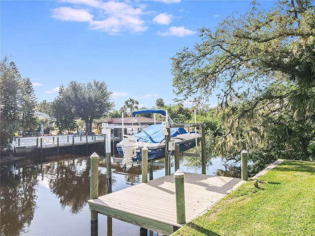 view of dock featuring a yard and a water view