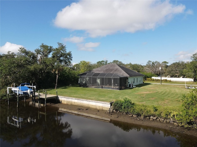 view of dock featuring a water view, a lanai, and a lawn