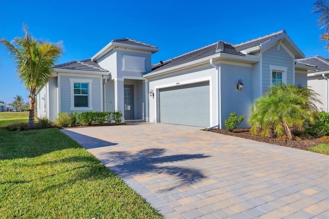 view of front of property featuring a front yard and a garage