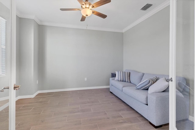 living room featuring ceiling fan and ornamental molding