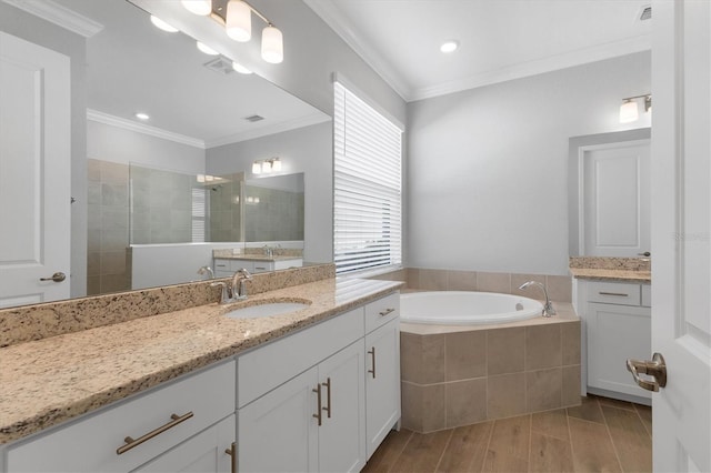 bathroom with separate shower and tub, a wealth of natural light, crown molding, and vanity