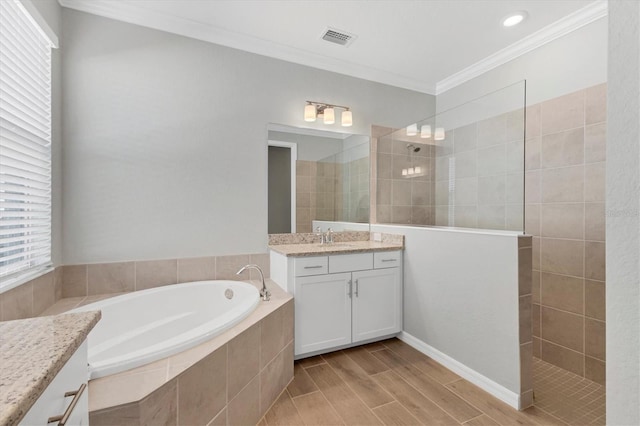 bathroom with crown molding, vanity, and independent shower and bath