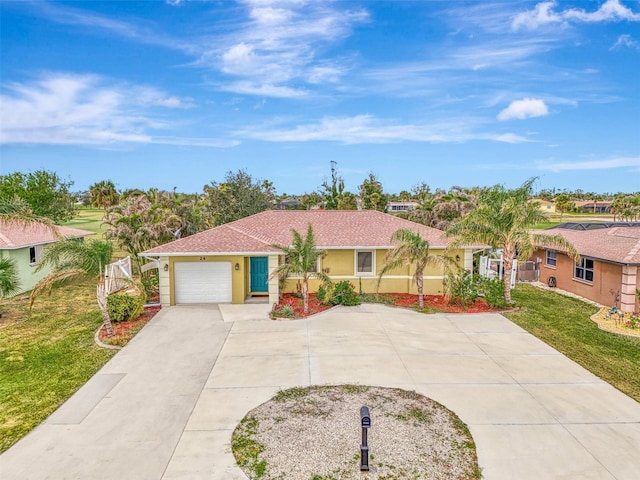 view of front of property with a front yard and a garage