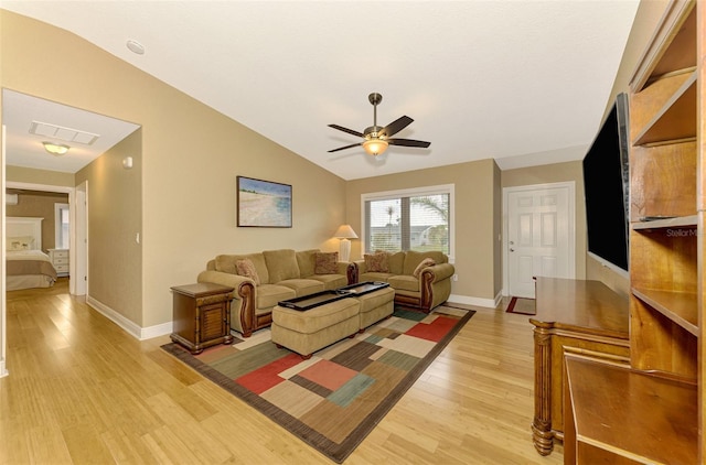 living room with light wood-type flooring, vaulted ceiling, and ceiling fan