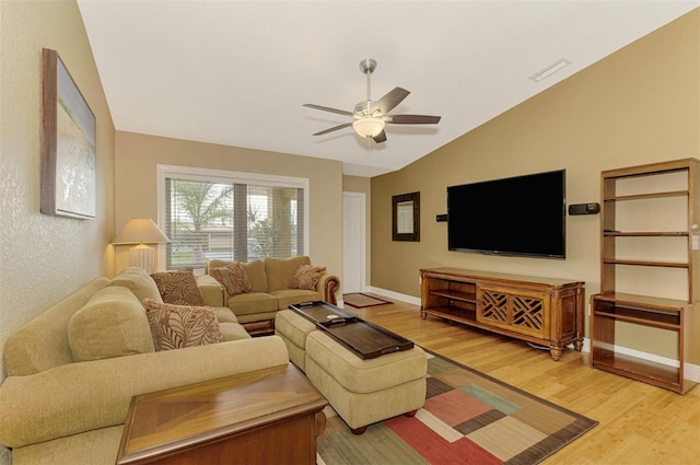 living room featuring wood-type flooring, vaulted ceiling, and ceiling fan