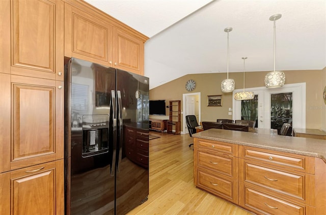 kitchen featuring french doors, light hardwood / wood-style flooring, pendant lighting, vaulted ceiling, and black fridge with ice dispenser