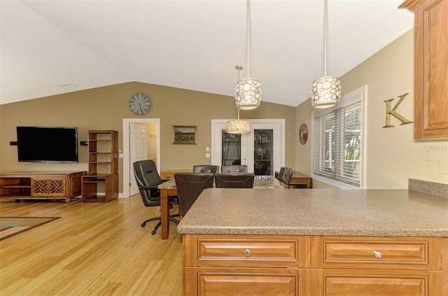 kitchen with kitchen peninsula, french doors, light hardwood / wood-style flooring, hanging light fixtures, and lofted ceiling