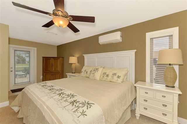 carpeted bedroom featuring a wall mounted air conditioner and ceiling fan