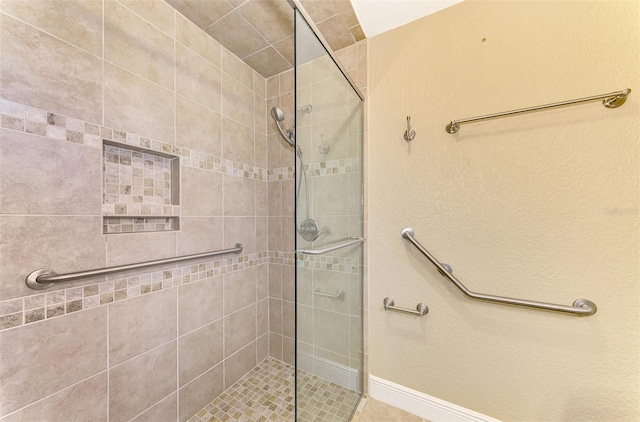 bathroom with tiled shower