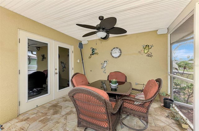 sunroom with ceiling fan and french doors