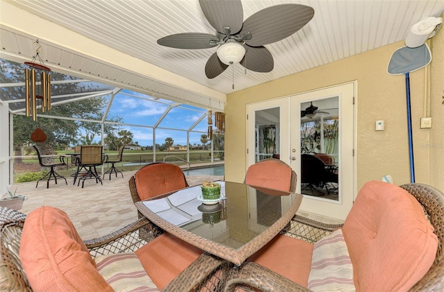 sunroom featuring ceiling fan and french doors