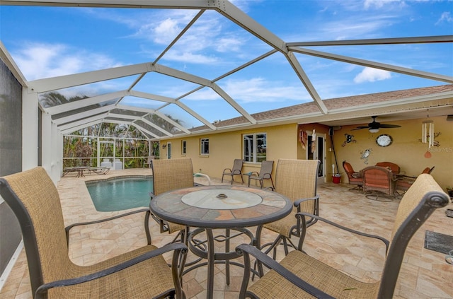 view of patio / terrace with ceiling fan and a lanai