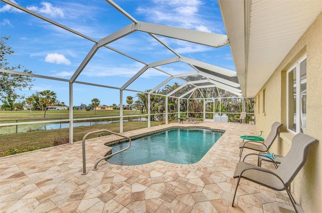 view of swimming pool featuring a water view, glass enclosure, a patio area, and a lawn