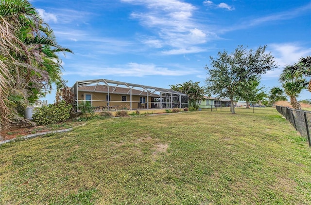 view of yard with glass enclosure