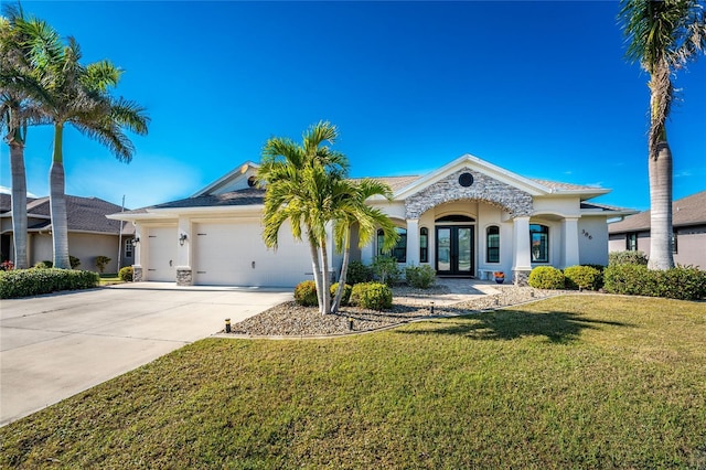 view of front facade with french doors, a garage, and a front lawn