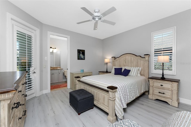 bedroom featuring ceiling fan, light hardwood / wood-style floors, and ensuite bath