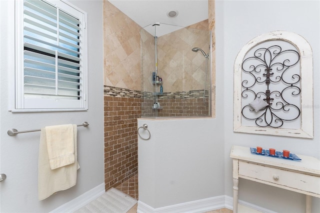 bathroom with a tile shower