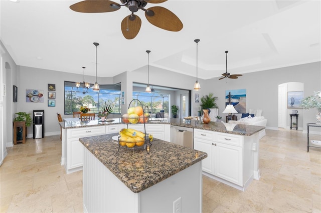 kitchen with dishwasher, a center island, dark stone counters, ceiling fan, and white cabinets