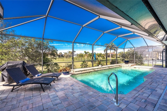 view of swimming pool featuring a lanai and a patio area