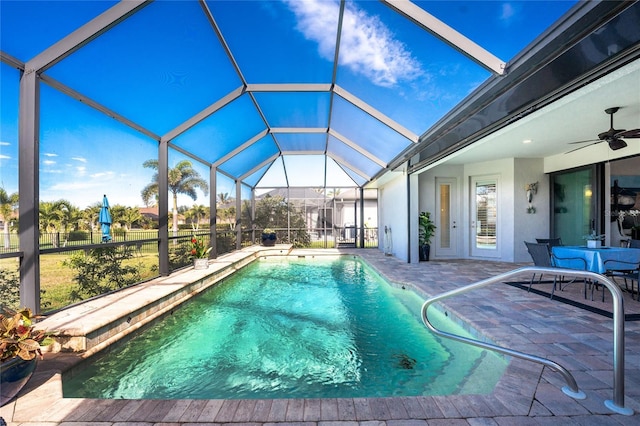 view of swimming pool featuring a lanai, a patio, and ceiling fan