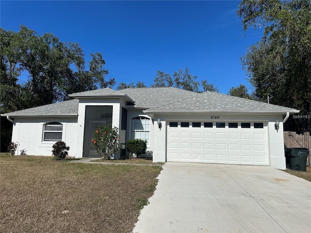 ranch-style house with a front lawn and a garage