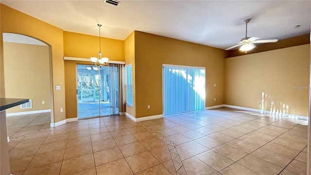 unfurnished room featuring light tile patterned floors and ceiling fan with notable chandelier